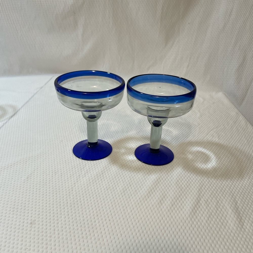 Hand blown Mexican Margarita Glasses with blue rim and base and clear bowl.